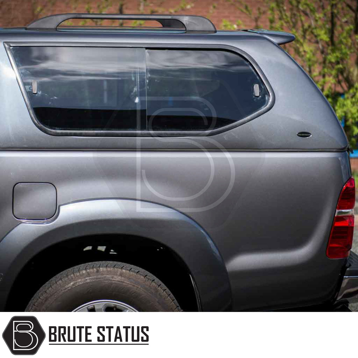Toyota Hilux 2005-2016 MK6, MK7 Truckman GLS Hardtop Canopy, showcasing rear-quarter view with fiberglass shell, tinted sliding windows, and Brute Status branding.