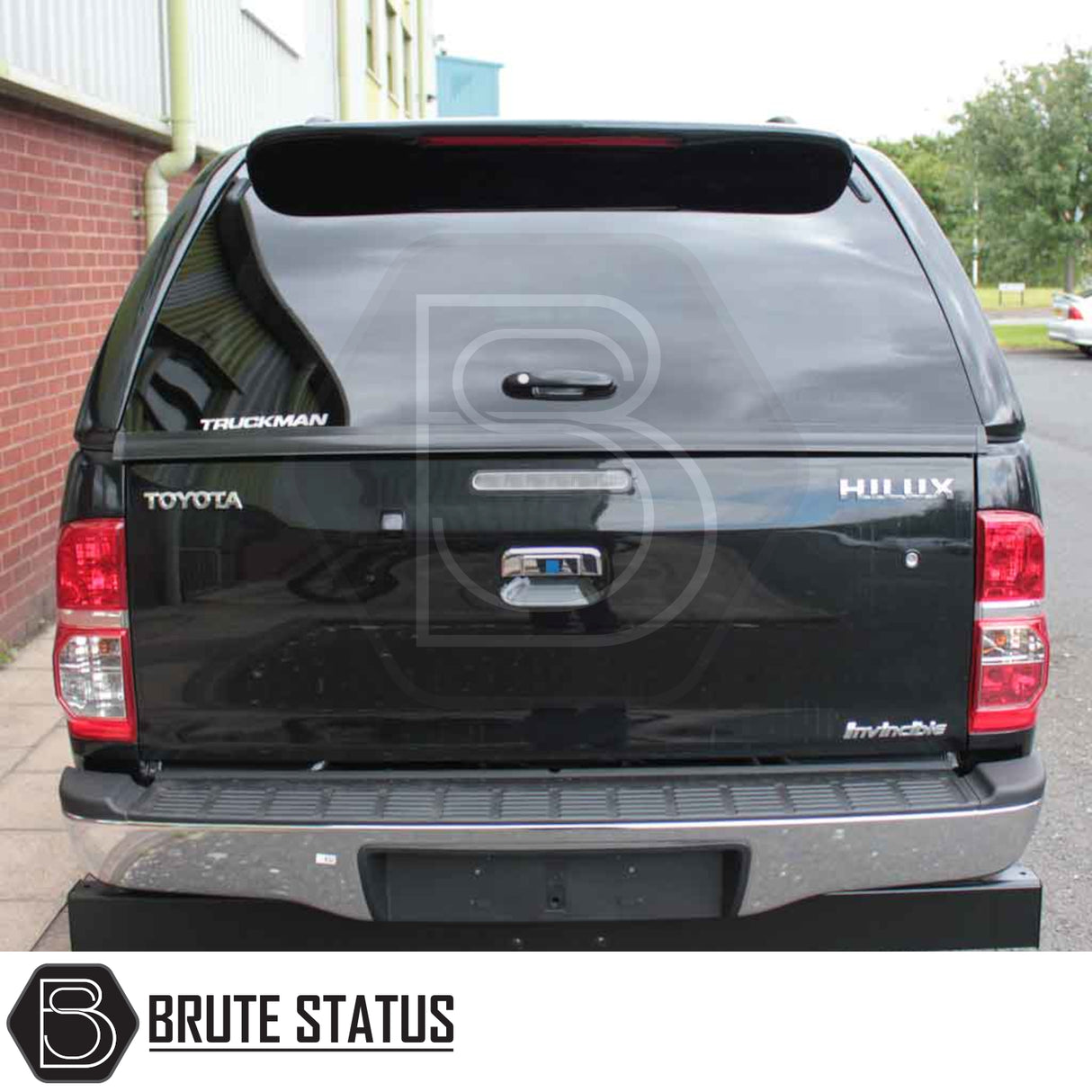 Rear view of Toyota Hilux 2005-2016 pickup with Truckman GLS Hardtop Canopy, featuring remote locking, sliding windows, and tailgate handle for enhanced storage and security.