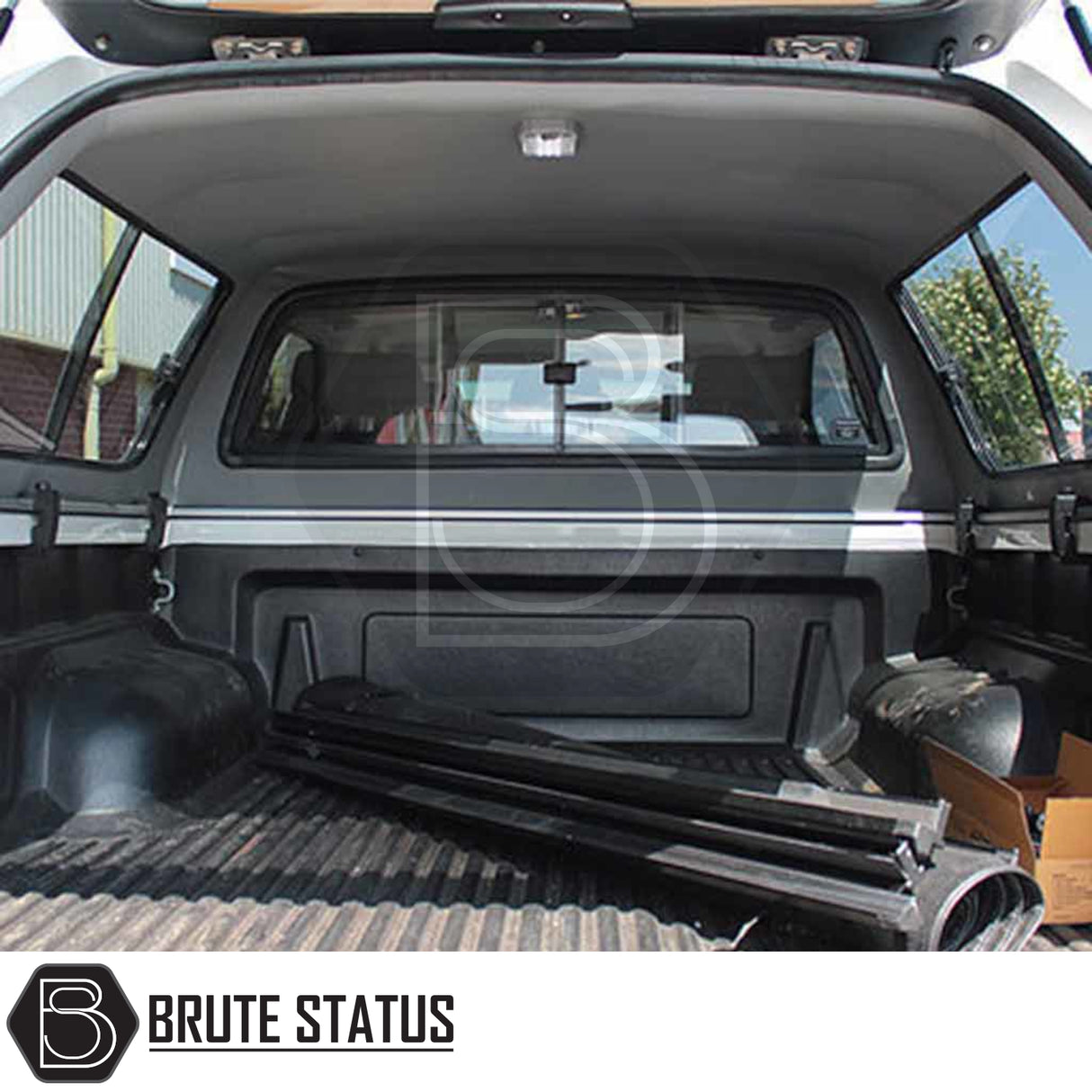 Toyota Hilux 2005-2016 Truckman GLS Hardtop Canopy with ribbed bedliner, lockable sliding windows, and metal bed-rail mounts, enhancing storage and ventilation for pets.