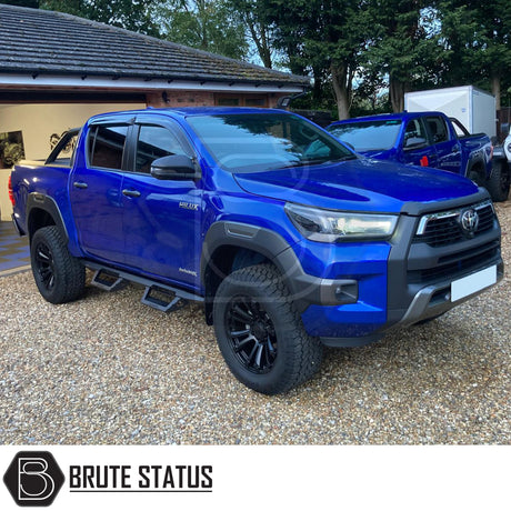 Toyota Hilux 2015+ Heavy Duty T32 Steel Side Steps in matt black, shown mounted on a truck, highlighting durable steel construction and sleek design.