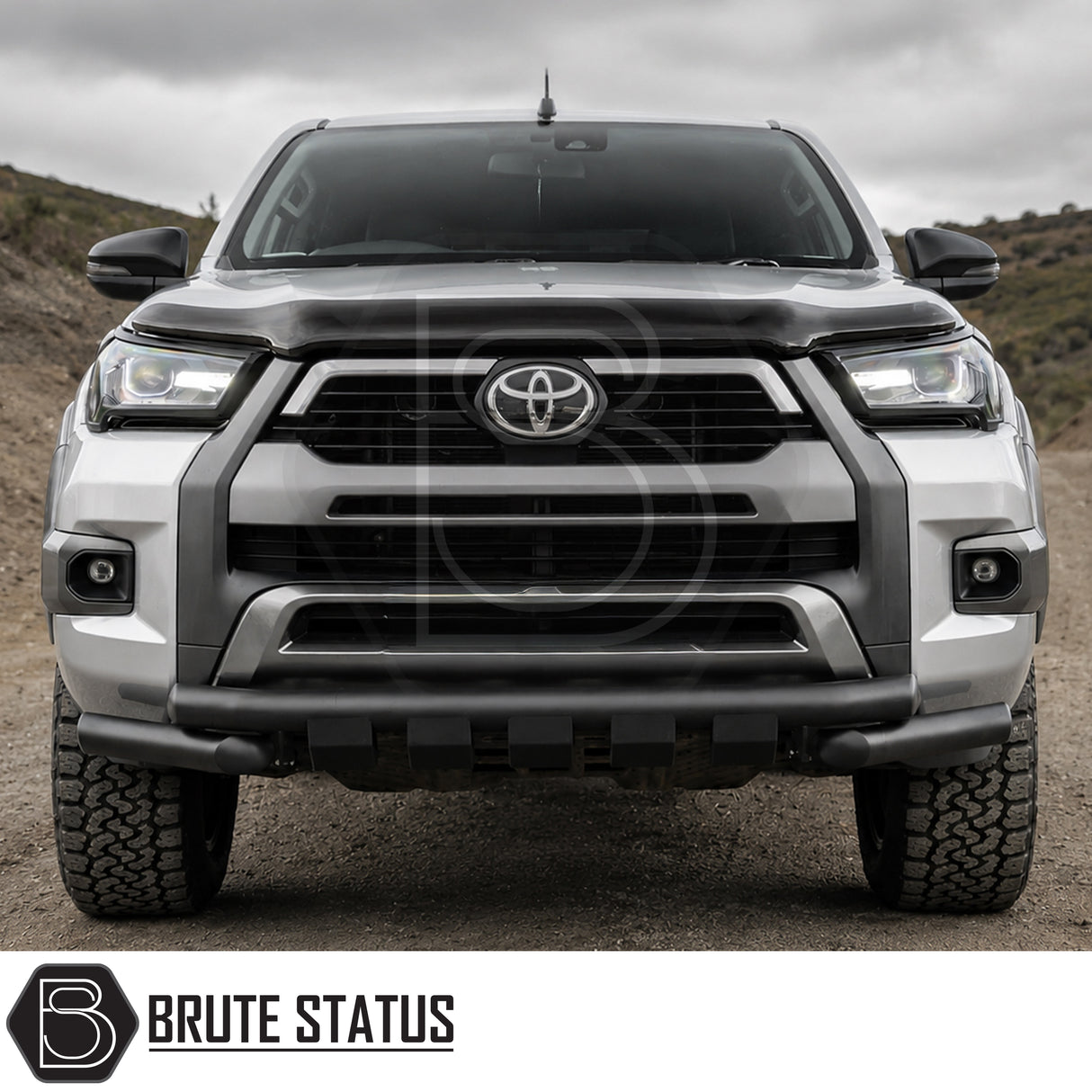 Front mounting heavy duty matte black powder coated nudge bar fitted to silver Toyota Hilux 2020+ pickup truck offroad 4x4 vehicle.