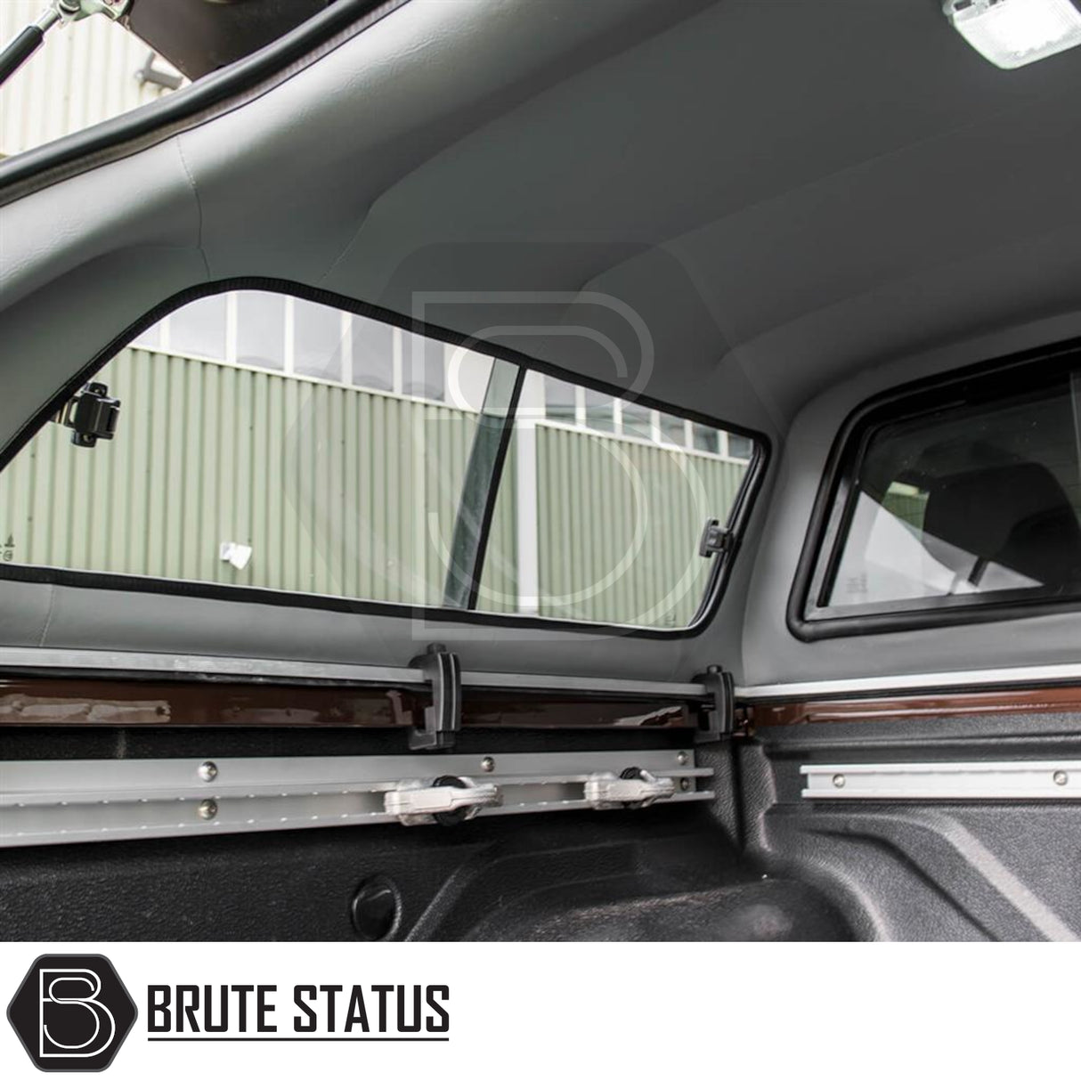 Toyota Hilux Invincible X Truckman GLS Canopy interior, showcasing cargo rails, sliding windows, molded headliner, and textured bed liner for secure gear management.