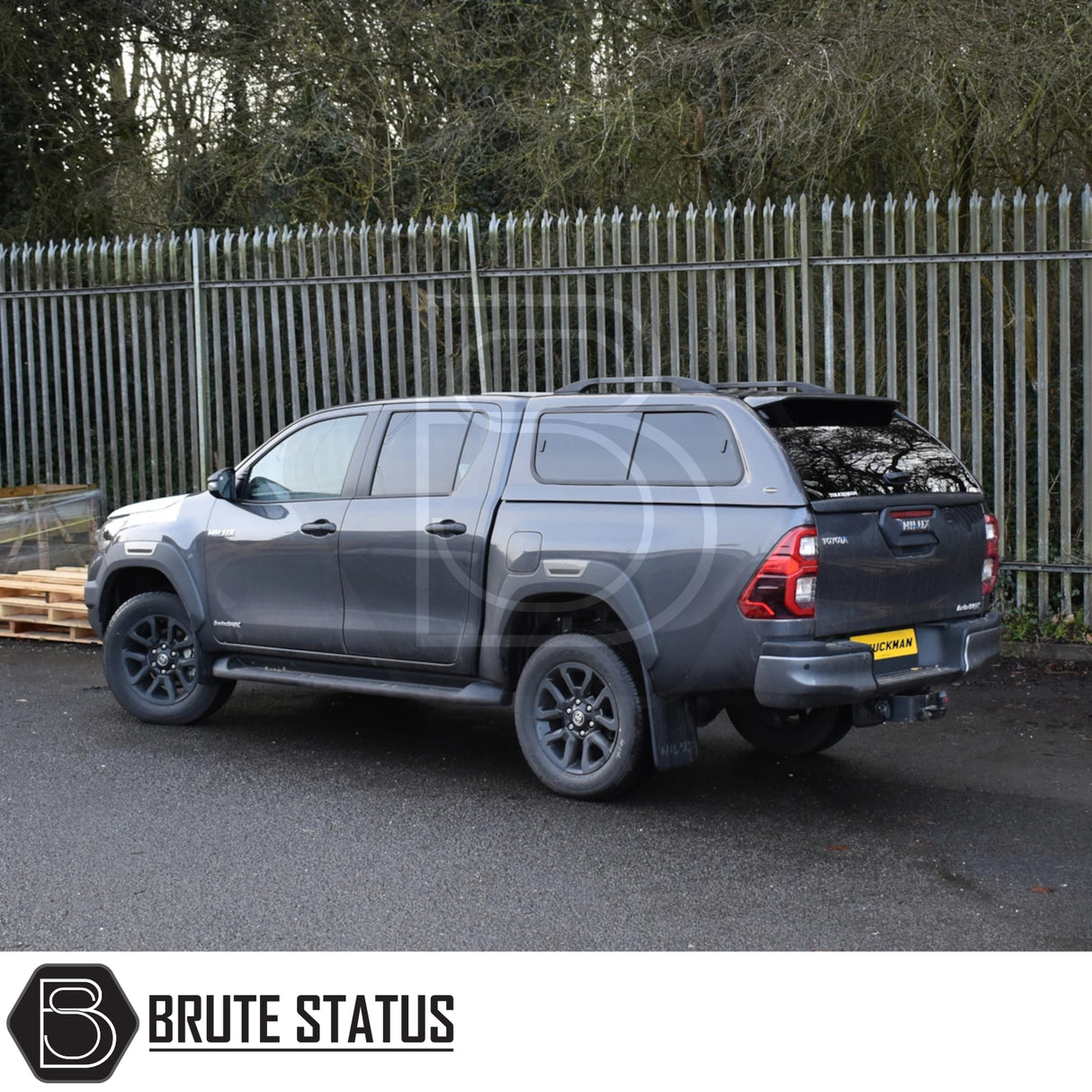 Toyota Hilux Invincible X 2016+ MK8, MK9 with Truckman GLS Hardtop Canopy featuring remote locking and lockable sliding windows, parked beside a security fence.