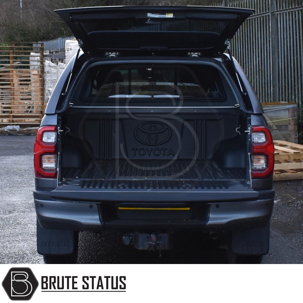 Toyota Hilux Invincible X Truckman GLS canopy with open tailgate, showcasing empty bed liner and branded logo, emphasizing remote locking and enhanced storage.