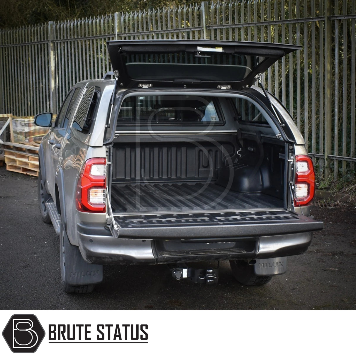 Toyota Hilux Invincible X Truckman Grand Canopy with remote locking, open to show empty bed liner, enhancing storage and security features.