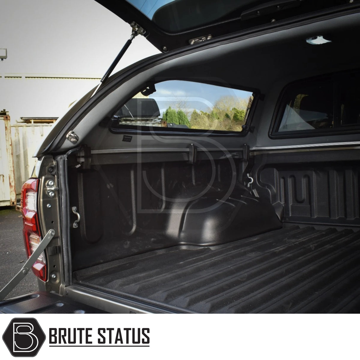 Toyota Hilux Invincible X 2016+ MK8, MK9 Truckman Grand Hardtop Canopy with open hatch, showcasing empty ribbed truck bed and Brute Status logo.