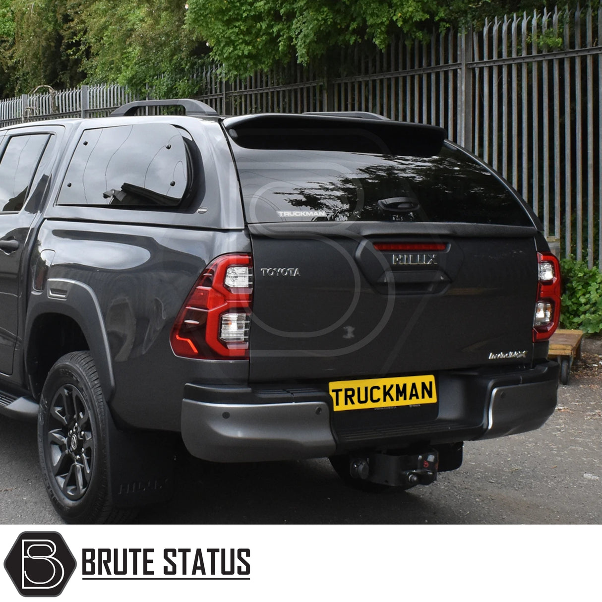 Toyota Hilux Invincible X with Truckman Grand Hardtop Canopy, featuring tinted windows and remote locking, enhancing the truck's style and functionality.
