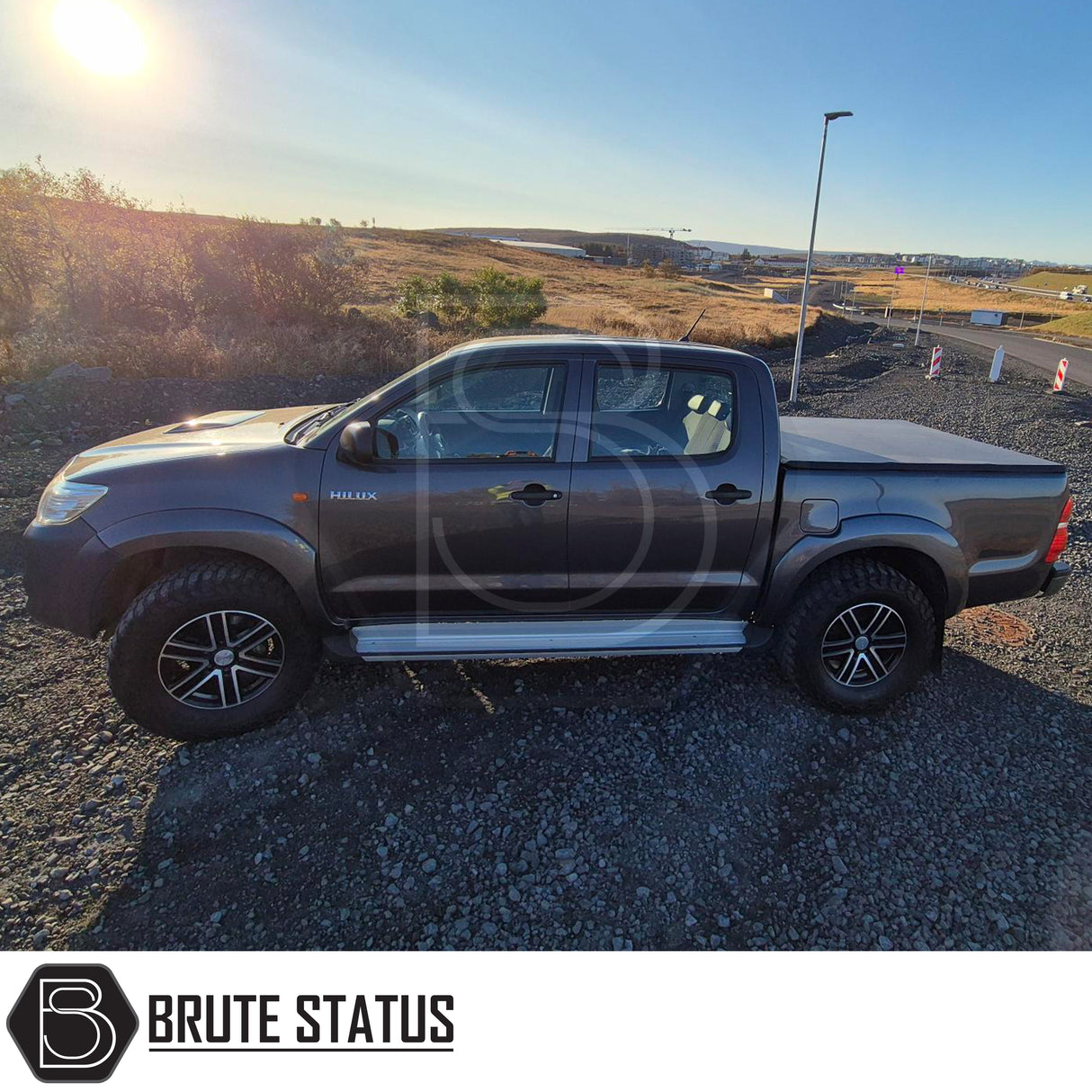 Toyota Hilux 2005-2014 Tonneau Cover, tri-fold design, enhances aerodynamics, UV-stable vinyl, aluminium securing catch, easy install, no drilling required.