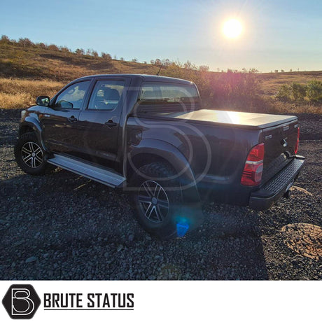 Toyota Hilux 2005-2014 Tonneau Cover, tri-fold design, enhances aerodynamics, UV-stable vinyl, aluminium securing catch, easy install, no drilling required.
