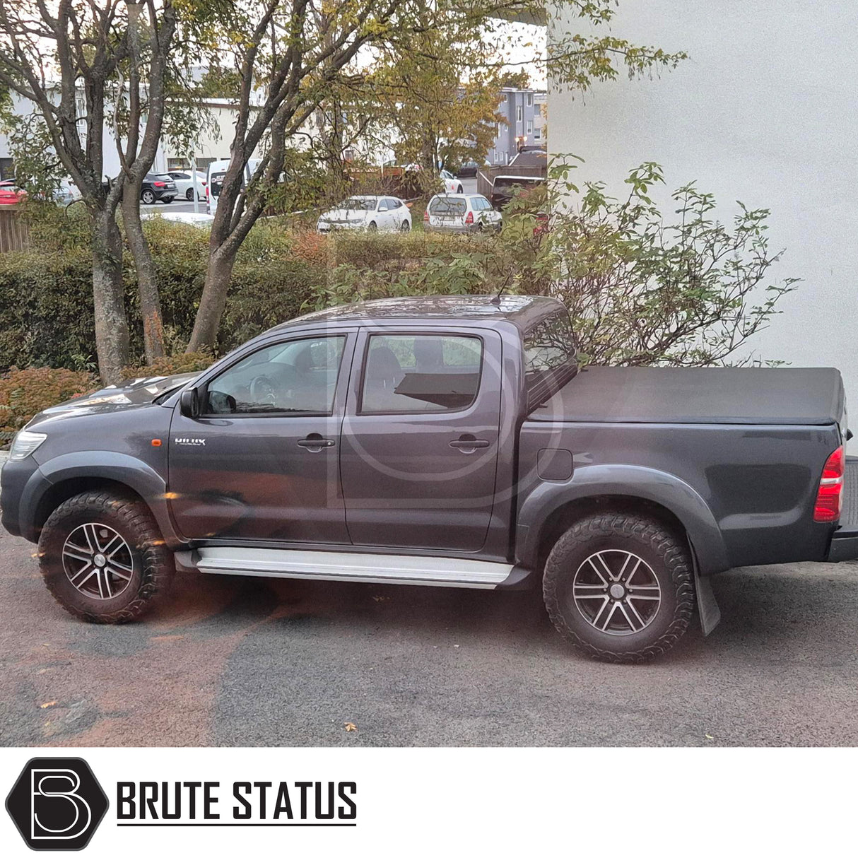 Toyota Hilux 2005-2014 Tonneau Cover, tri-fold design, enhances aerodynamics, UV-stable vinyl, aluminium securing catch, easy install, no drilling required.