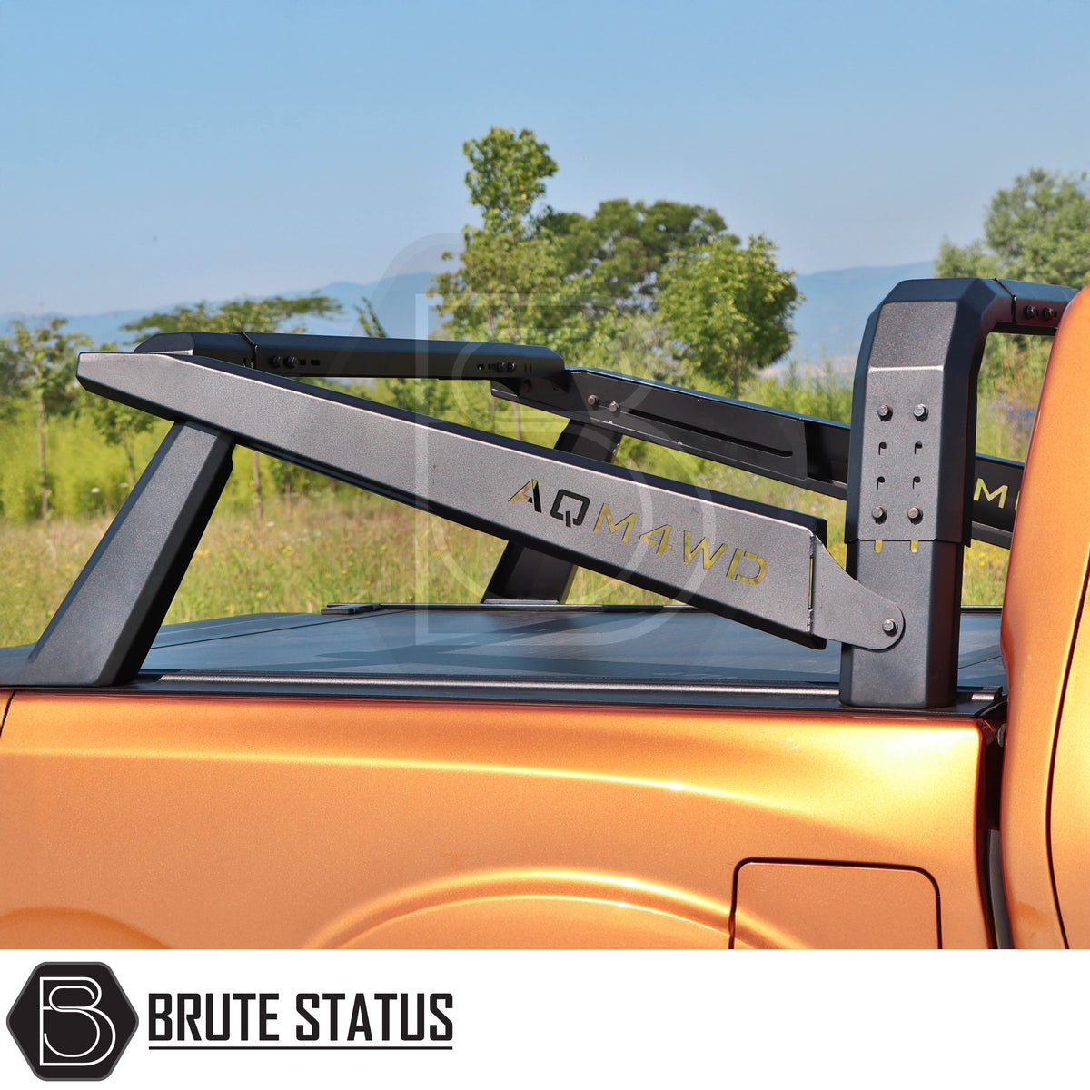Heavy duty universal S70 roof tent roll bar for European pickup trucks with adjustable height and durable matte black steel construction fitted onto orange pickup truck.