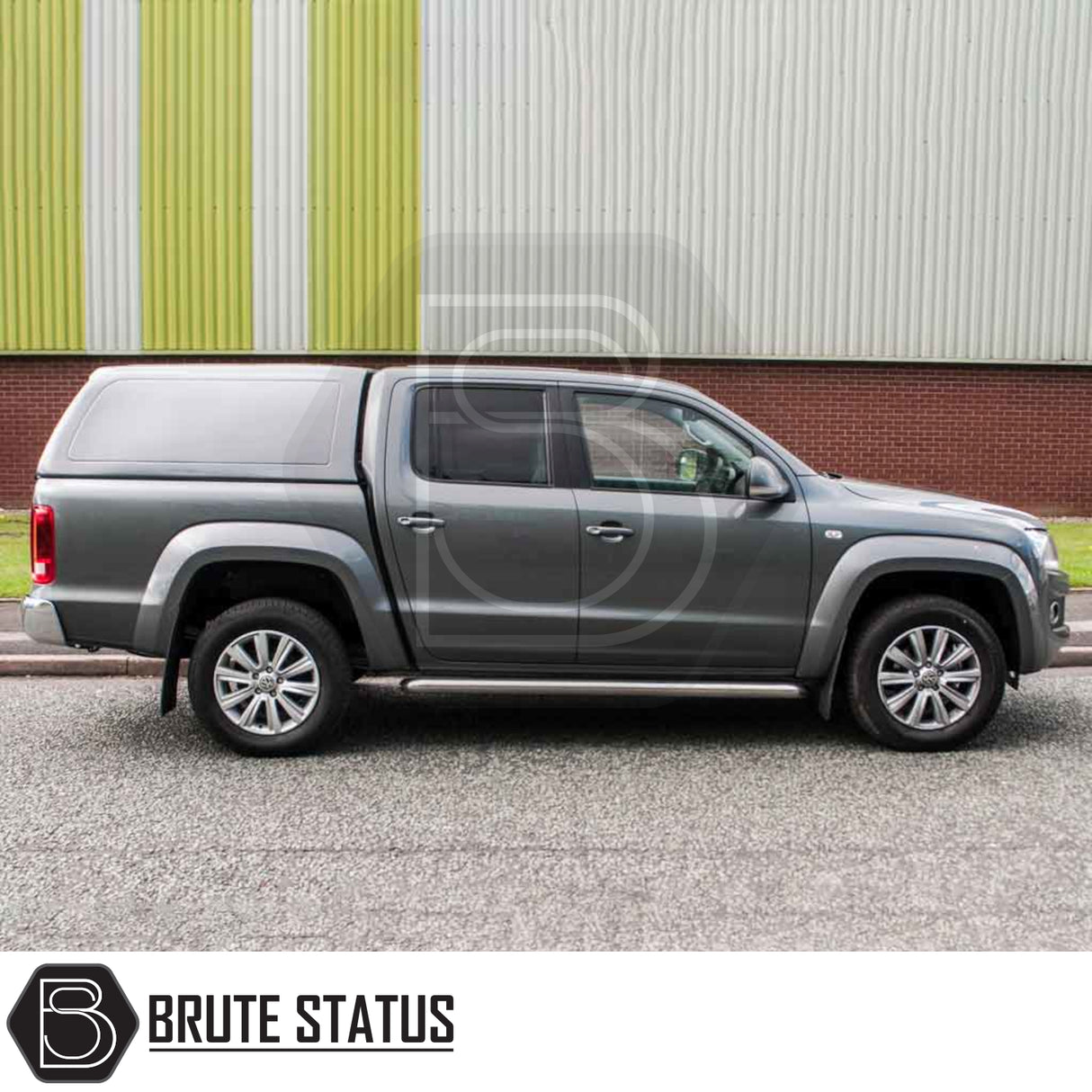 Volkswagen Amarok 2010-2022 fitted with Truckman RS Hardtop Canopy, featuring solid rear window and remote locking, parked by an industrial building.