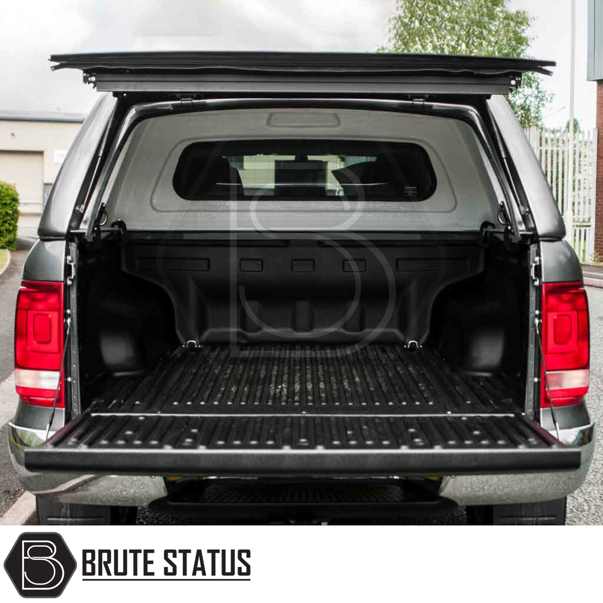 Volkswagen Amarok 2010-2022 Truckman RS Hardtop Canopy with solid rear window and remote locking, shown on a pickup truck with open tailgate and flipped-up cover.
