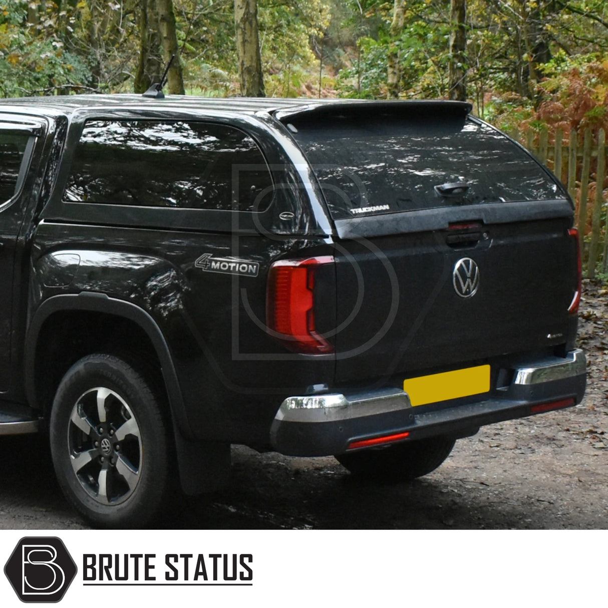 Volkswagen Amarok 2023+ with Truckman Grand Hardtop Canopy featuring remote locking and aftermarket design, parked on a woodland track.