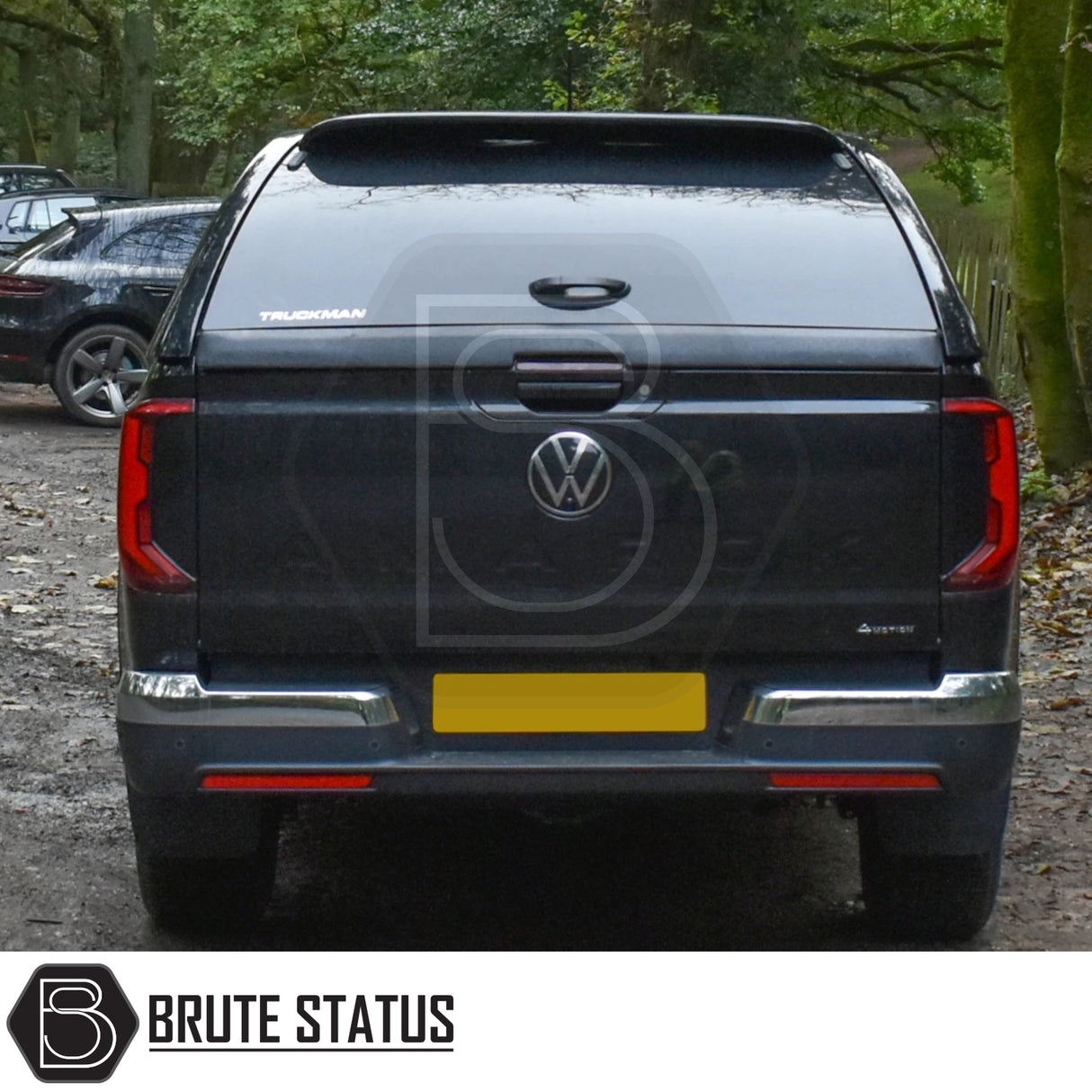 Volkswagen Amarok 2023+ Truckman Grand Hardtop Canopy with remote locking, featuring tinted windows and chrome-trimmed bumper, parked on a forest track.