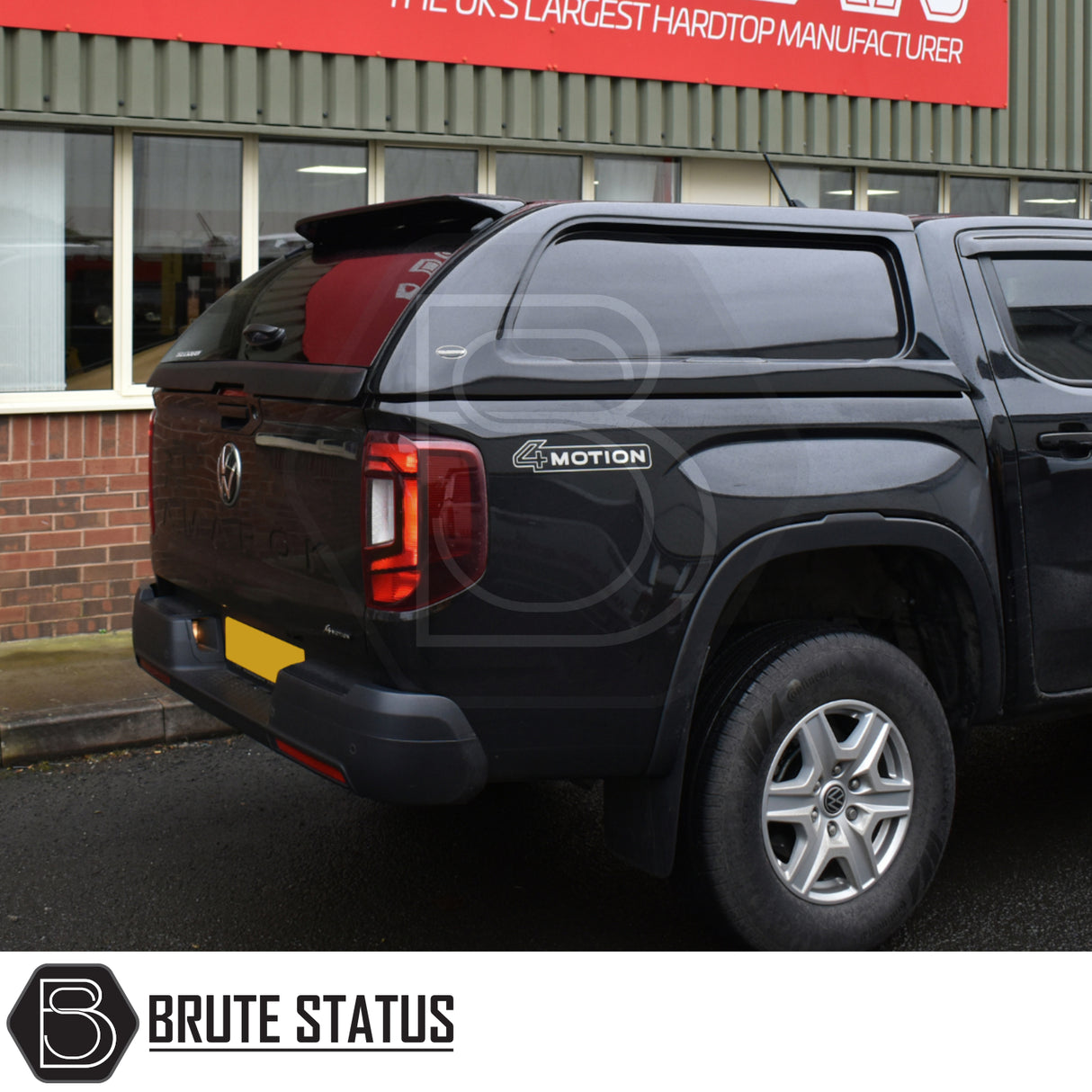 Black Volkswagen Amarok with Truckman L-Series hardtop canopy, featuring remote locking and tinted windows, displayed at Brute Status, the UK's largest hardtop manufacturer.
