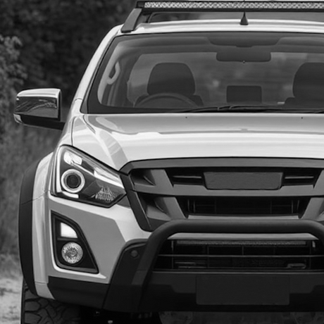 A parked silver Isuzu D-max, highlighting aftermarket accessories, reflecting Brute Status's focus on unique vehicle optimizations for enhanced individuality and style.