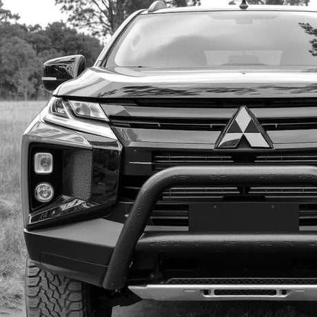 A black 2020 Mitsubishi L200 with a bull bar, showcasing aftermarket modifications, parked outdoors. Perfect for customization enthusiasts seeking unique vehicle enhancements.