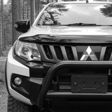 Black and white photo of a Mitsubishi L200 MK5 with roof rack, highlighting vehicle's exterior and aftermarket accessories, reflecting Brute Status's specialization in custom optimizations.