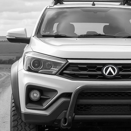 A parked SsangYong Musso on a road, showcasing aftermarket accessories, reflecting Brute Status's focus on enhancing pick-up truck individuality and style.