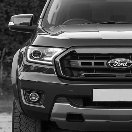 Front view of a sport utility vehicle, highlighting the grille and bumper, suitable for aftermarket customizations offered by Brute Status.