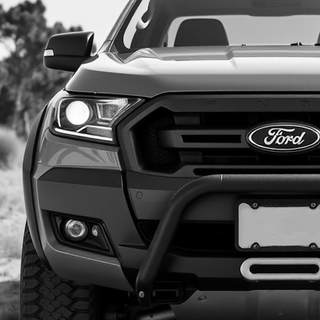 Close-up of a sport utility vehicle with visible tire and bumper, highlighting aftermarket enhancements for improved style and individuality from Brute Status.