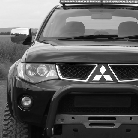 Black and white photo of a sport utility vehicle featuring aftermarket accessories, highlighting the rugged design and customization options available at Brute Status.