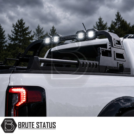 Heavy duty combat style matte black powder coated roll bar fitted to Ford Ranger 2023+ pickup truck offroad 4x4, fitted with additional lighting for extra visibility. 