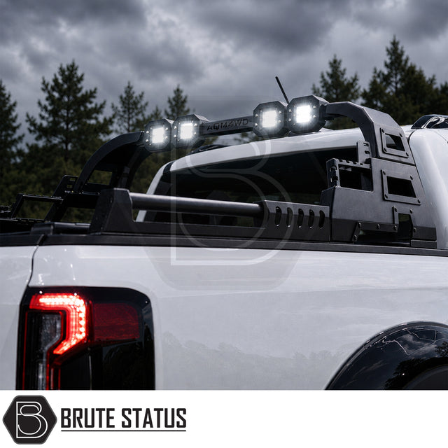 Heavy duty combat style matte black powder coated roll bar fitted to Ford Ranger 2023+ pickup truck offroad 4x4, fitted with additional lighting for extra visibility. 