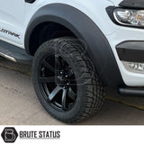 AXE Wheels Quake in Matt Black, showcasing a close-up of the alloy wheel rim with a distinctive red logo, highlighting its design and craftsmanship.