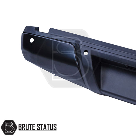 Black rear bumper for Nissan Navara NP300 (2015–2022), featuring a sleek factory-style finish, pre-drilled holes for OEM parking sensors, non-slip foot steps with drainage channels, and a durable, direct bolt-on design for easy installation and rugged use