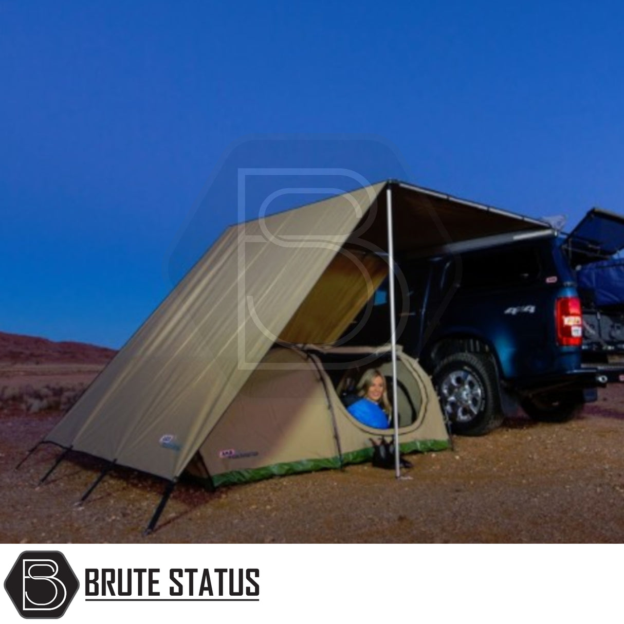 ARB Flinders Rooftop Tent on blue 4x4 truck in desert at dusk, showcasing compact setup with tent and awning, enhancing outdoor adventure comfort.