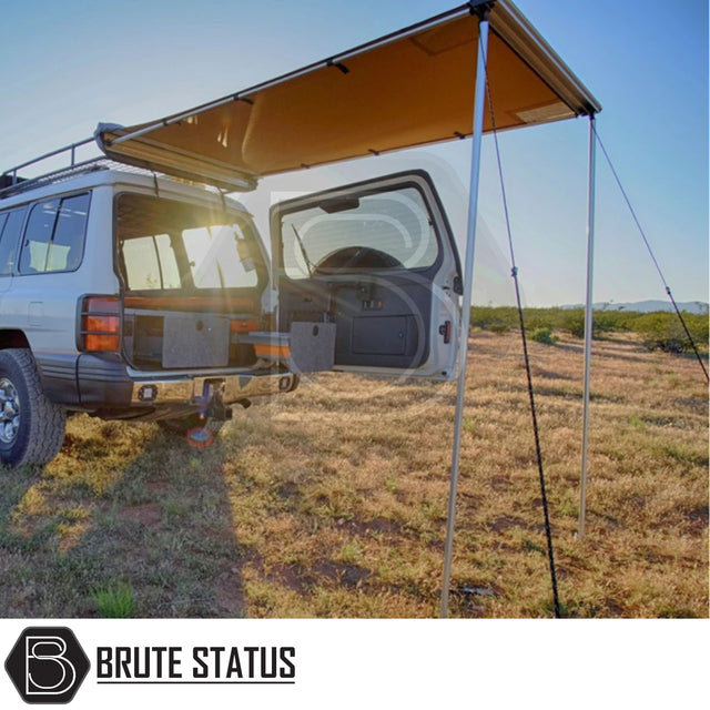 White 4x4 SUV with ARB Awning 1.25m x 2.1m extended, showcasing retractable awning and storage solutions, in a field at sunset.