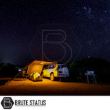 ARB Simpson III Rooftop Tent & Annex on a 4×4 SUV, showcasing a night-time off-road camping setup with awning, tent, chairs, and table under a starry sky.