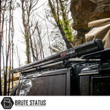 Side view of a 4x4 with ARB Aluminium Case Black Awning & LED Light Kit, stowed on roof rack, showcasing rugged, off-road accessory setup.