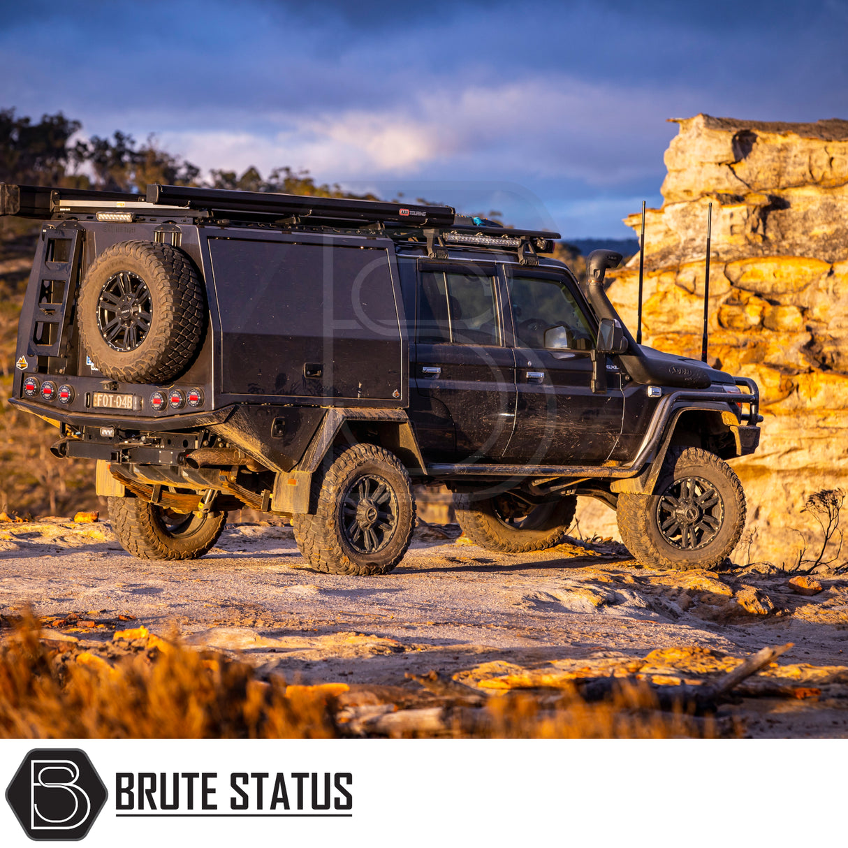 Modified black 4×4 with ARB Aluminium Case Black Awning & LED Light Kit at sunset, showcasing expedition-ready features like roof rack, snorkel, and LED lights.