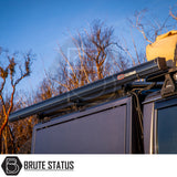 Side view of a roof rack with ARB Awning Alcove housing and gear bag, set against a sunset, showcasing Brute Status's off-road accessory appeal.