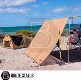 ARB PVC Case Awning & LED Light Kit 2.5m x 2.5m set up at a beach campsite, attached to a vehicle, providing shaded seating and lighting.