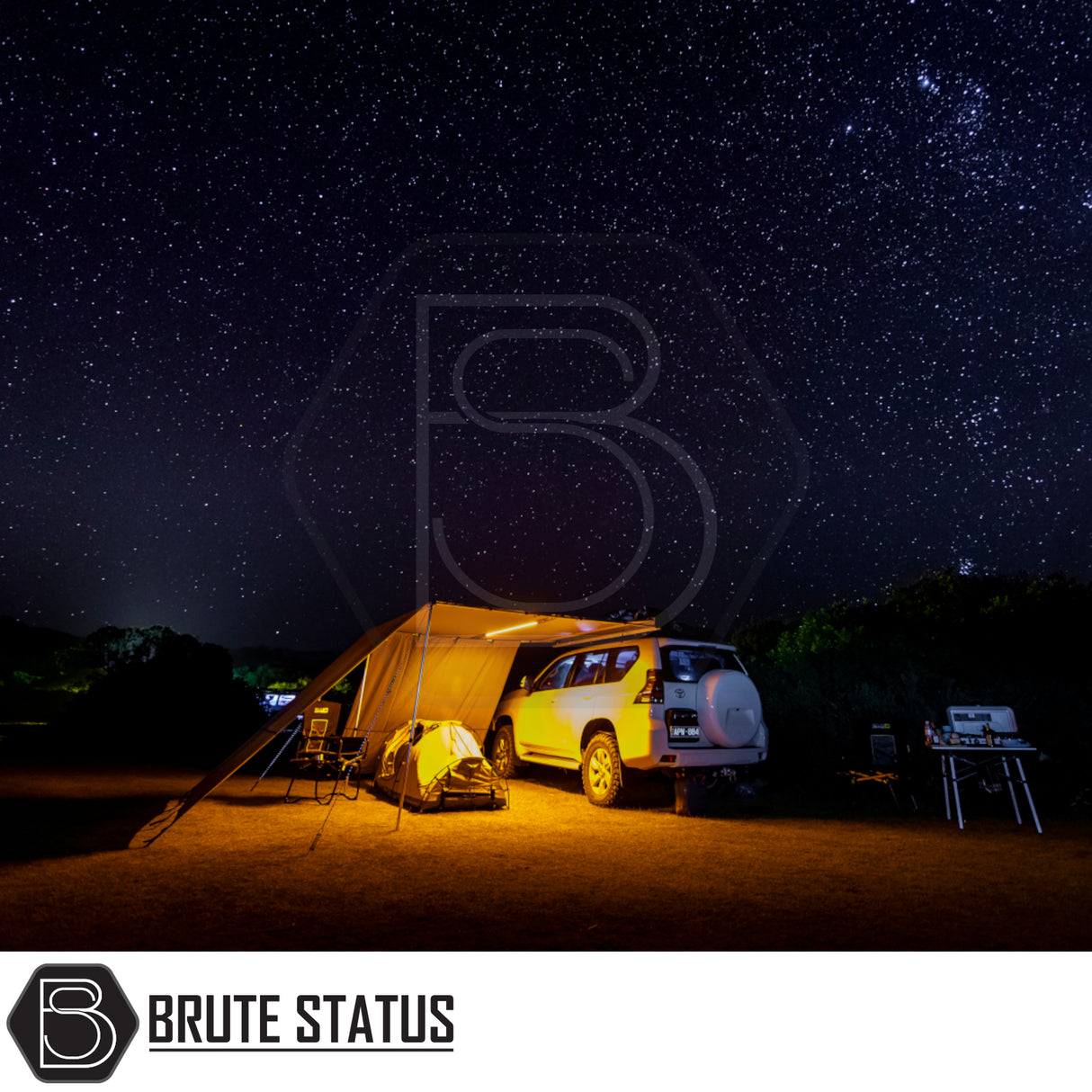 ARB Simpson III Rooftop Tent & Annex attached to SUV at night, featuring an illuminated annex, camping chairs, and kitchen setup, showcasing outdoor adventure convenience.