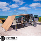 ARB Aluminium Case Awning & LED Light Kit 2.5m x 2.5m showcased on a beach, providing shade and light for an overland camping setup beside a 4WD vehicle.