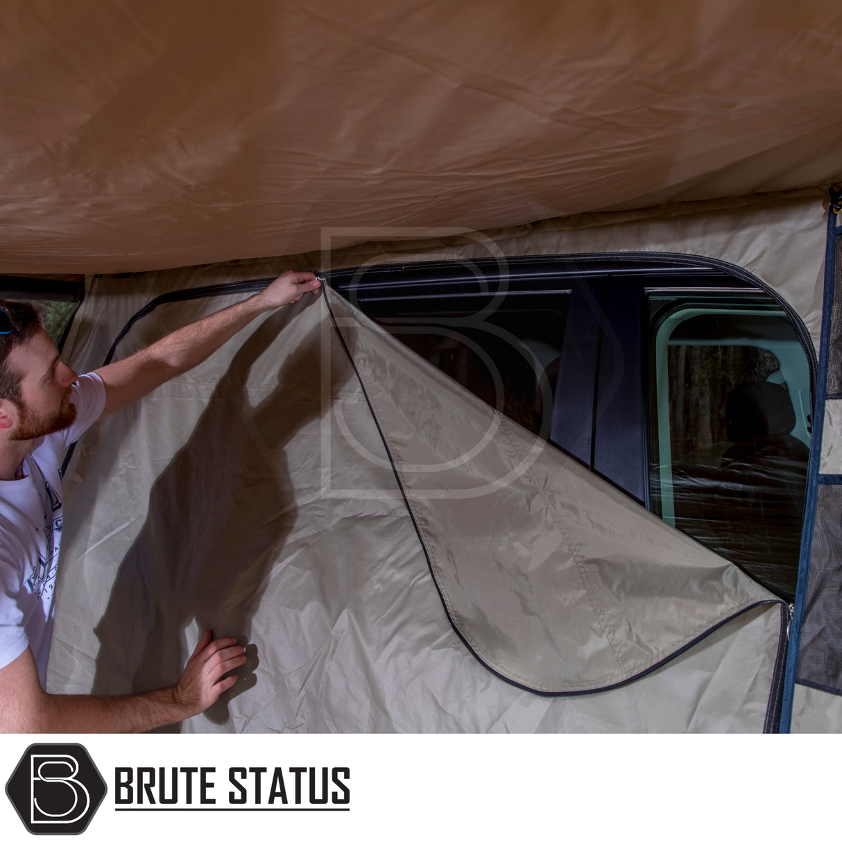 Man installs beige side-wall panel on vehicle-mounted ARB PVC Case Awning & LED Light Kit, showcasing its fitting on a car's roof rack.