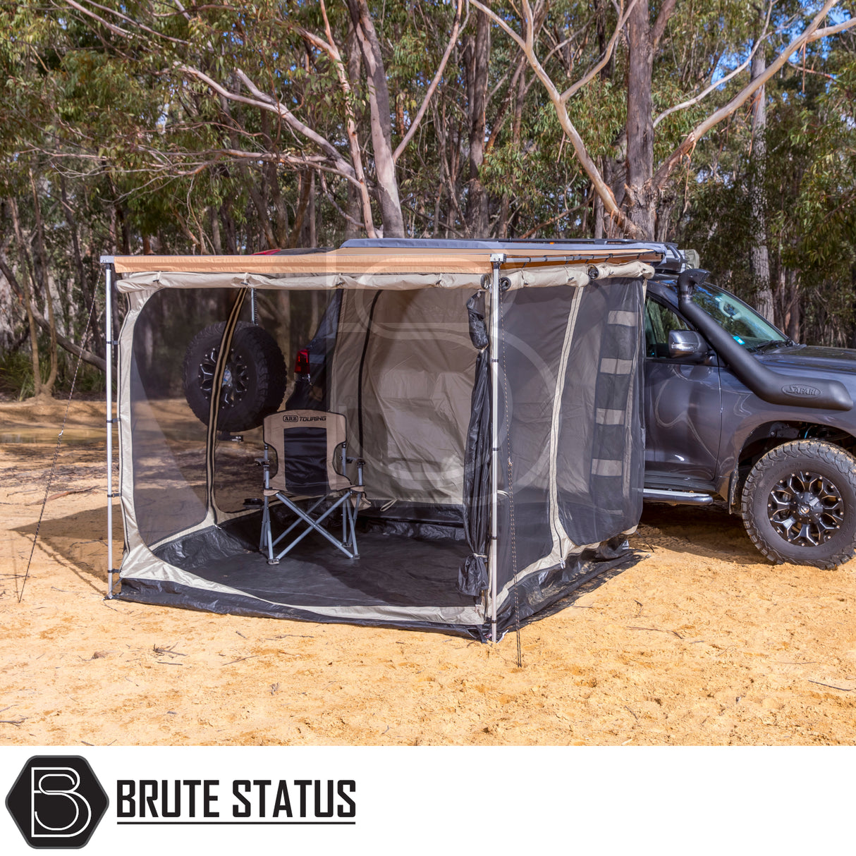 ARB Simpson III Rooftop Tent & Annex on a 4x4, showcasing its extended awning with mesh walls and camping chair, enhancing outdoor adventure comfort.
