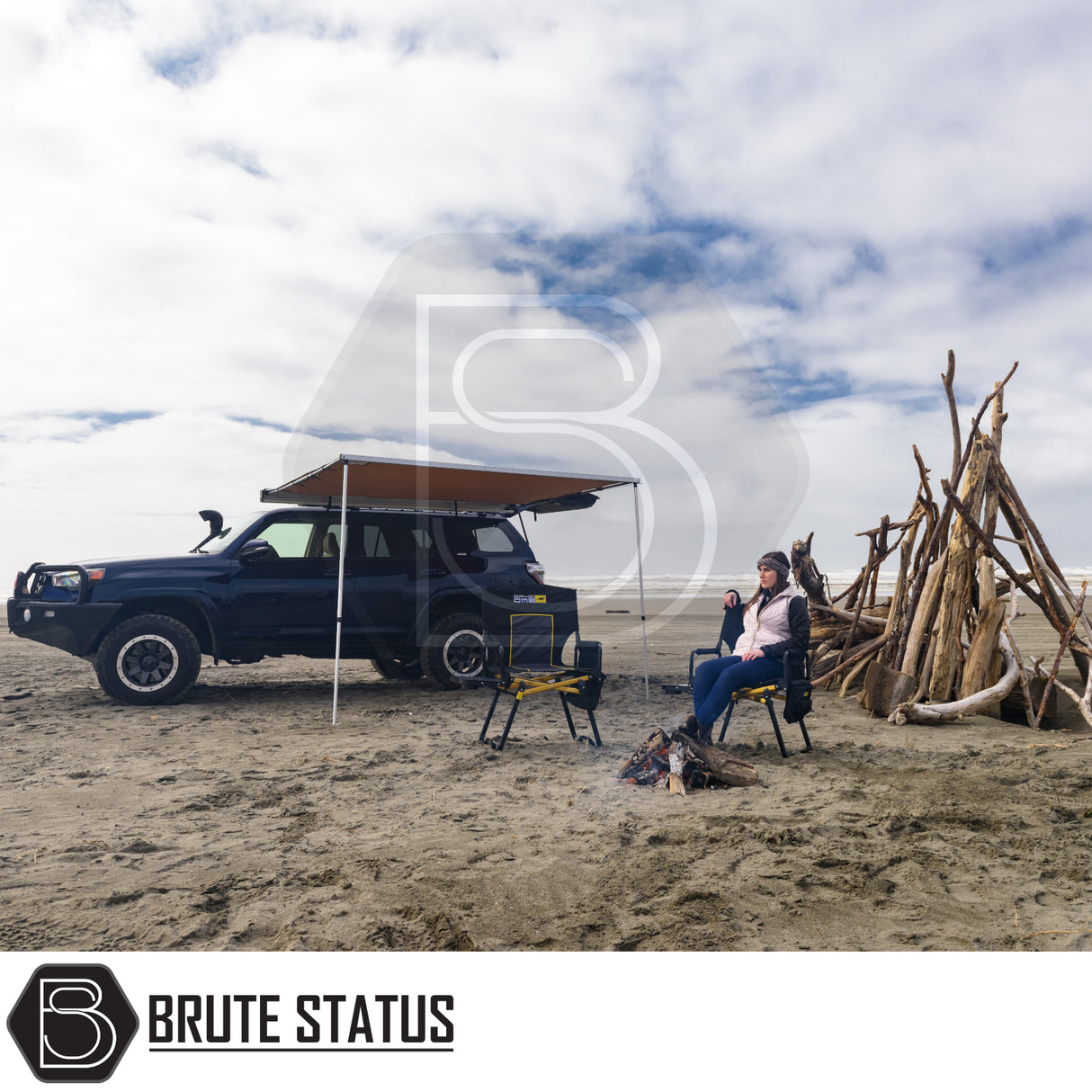 ARB Awning 2m x 2.5m extends from SUV, providing shade over camp chairs at beach campsite, showcasing easy setup and durability for outdoor adventures.
