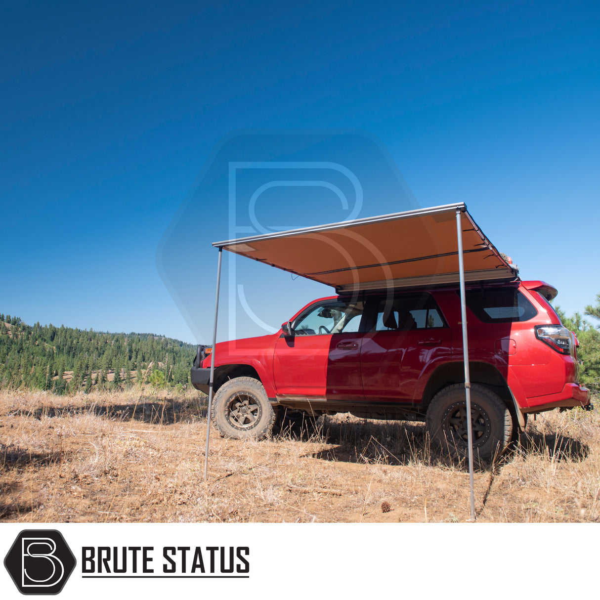Red off-road SUV with ARB Awning 2m x 2.5m deployed on hillside, showcasing convenient outdoor shelter and Brute Status branding.