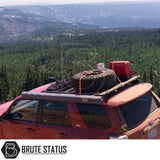 Red Toyota 4Runner with ARB Awning 2m x 2.5m on roof rack, alongside spare tire, jerry can, and recovery boards, parked at forested mountain overlook.