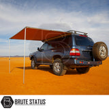 Off-road SUV with ARB Awning 2m x 2.5m deployed, showcasing a rugged camping setup under a desert sky, highlighting Brute Status craftsmanship.