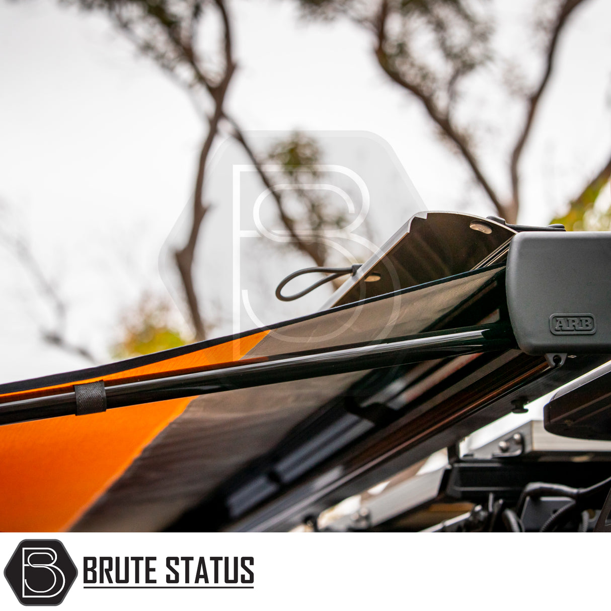 Close-up of ARB Aluminium Case Silver or Black Awning & LED Light Kit 2.5m x 2.5m, showcasing telescoping support and ARB-branded mounting hardware on an off-road vehicle.