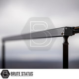 Close-up of ARB Aluminium Case Silver or Black Awning & LED Light Kit, showcasing black anodized aluminum cross-bar, vertical post, and ARB-branded clamp, part of Brute Status off-road hardware.