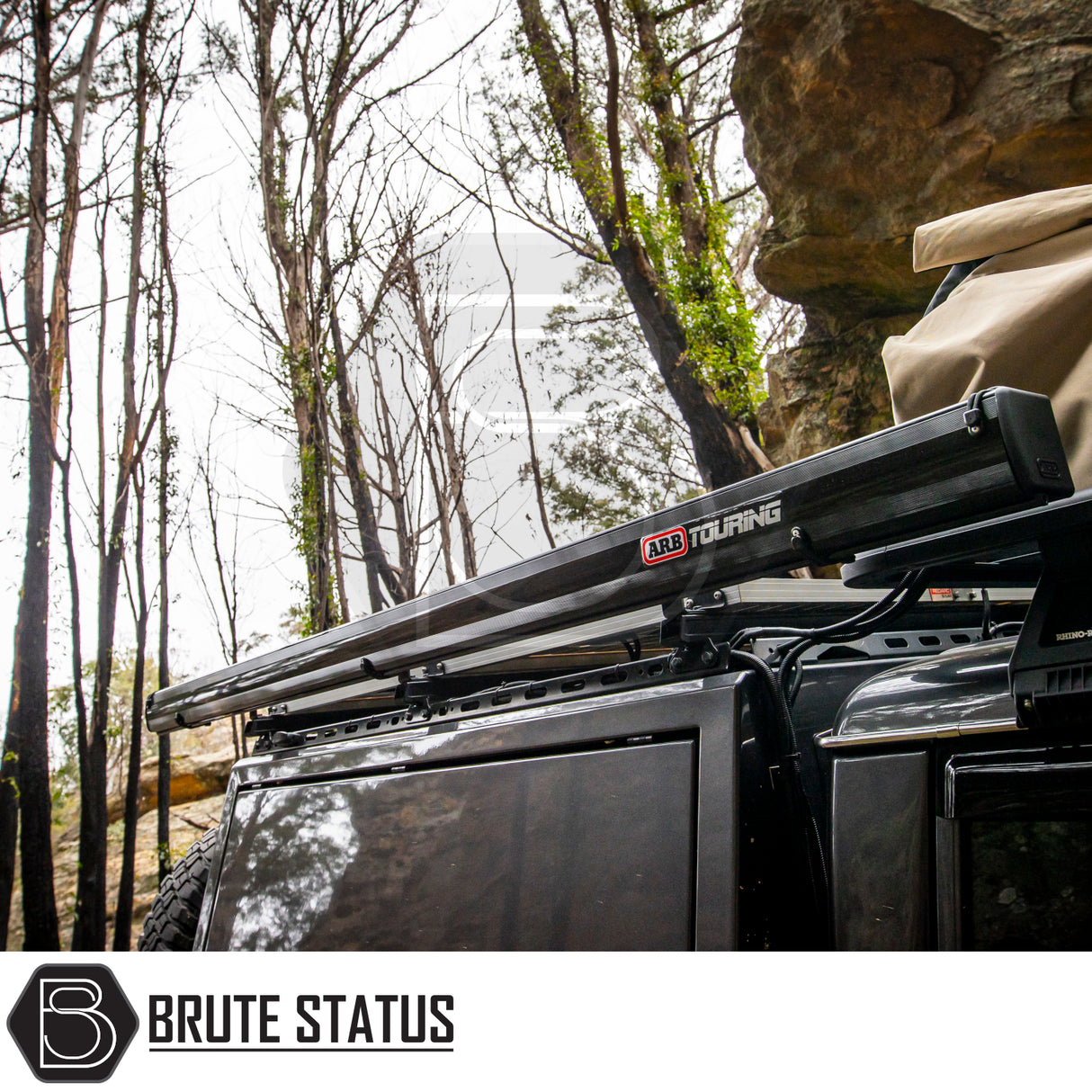 ARB Aluminium Case Awning & LED Kit on 4x4 in wooded area, showcasing its sleek design and practicality for outdoor adventures.