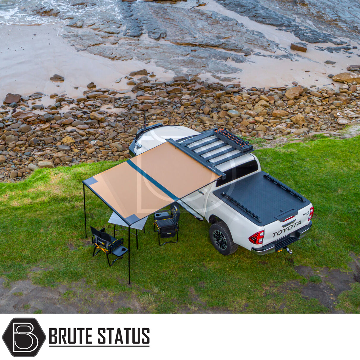 Toyota Hilux with ARB Aluminium Case Awning & LED Light Kit, 2.5m x 2.5m, extended over camping setup by a riverbank.